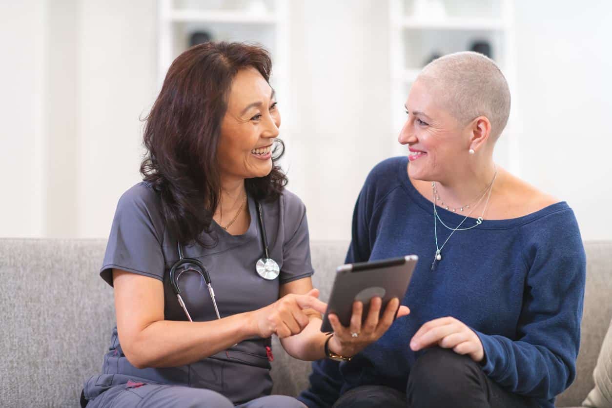 Doctor talking with a cancer patient on treatment plans to receive quality cancer care.