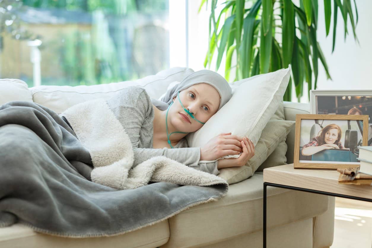 woman laying on couch dealing with the side effects of radiation therapy