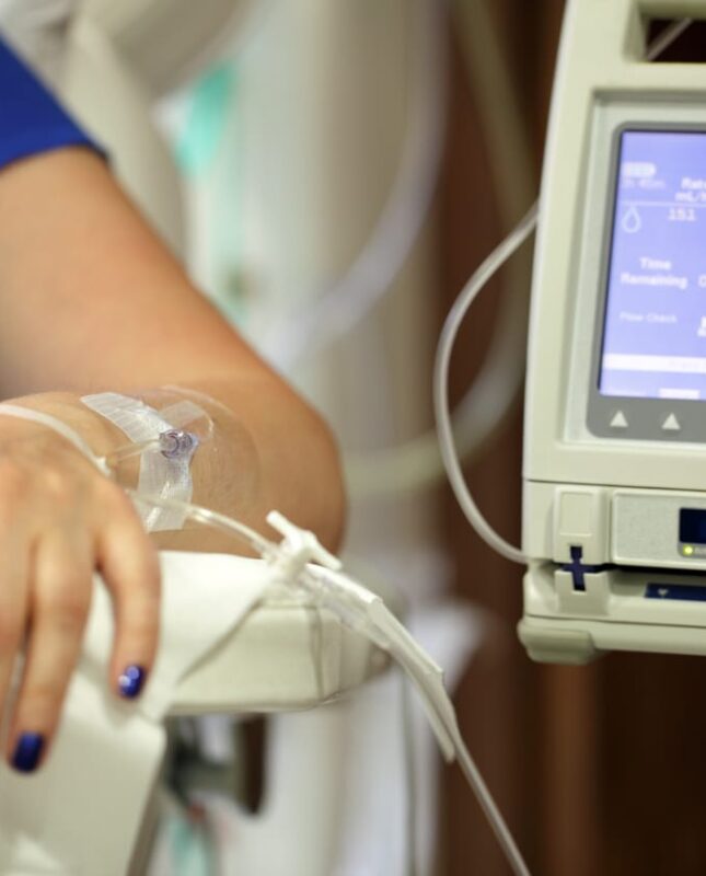 woman's arm being infused with medicine as she asks FAQ about chemotherapy