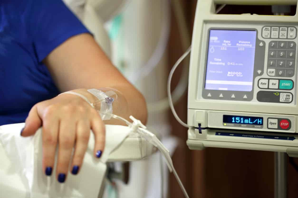 woman's arm being infused with medicine as she asks FAQ about chemotherapy